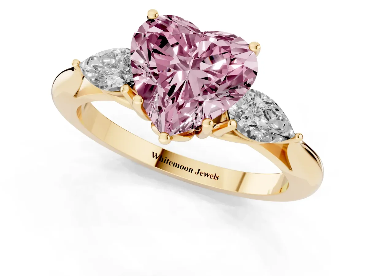 Fancy Pink Three-Stone Heart Cut Diamond Ring with Pear Side Stones in Four-Prong Setting Yellow gold