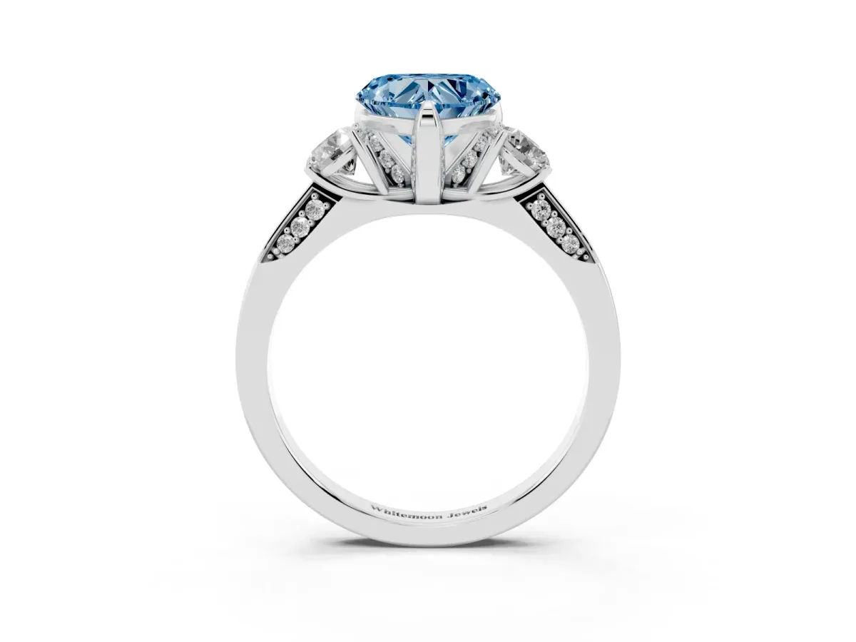 Fancy Blue Heart Cut Brilliant Three-Stone Diamond Ring with Pavé Band and Four-Prong Setting Platinum