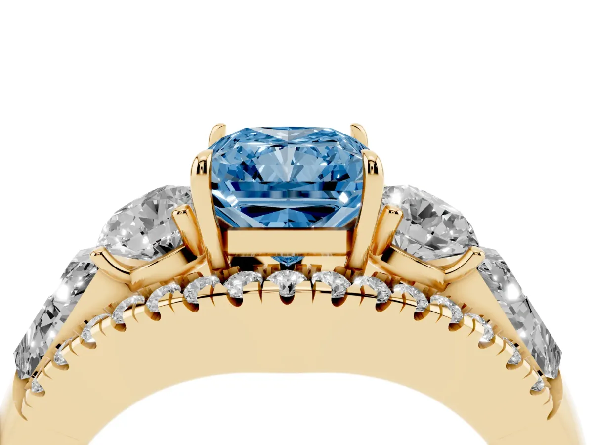 Fancy Blue Three-Stone Radiant Cut Diamond Engagement Ring with Pave Band and Prong Setting Yellow gold