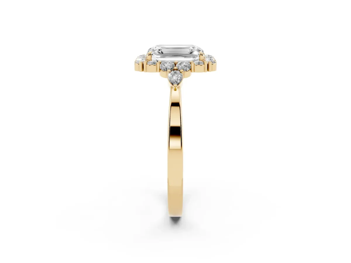 Emerald Cut Diamond Halo Ring with Pear Side Stones and Prong Setting Yellow gold