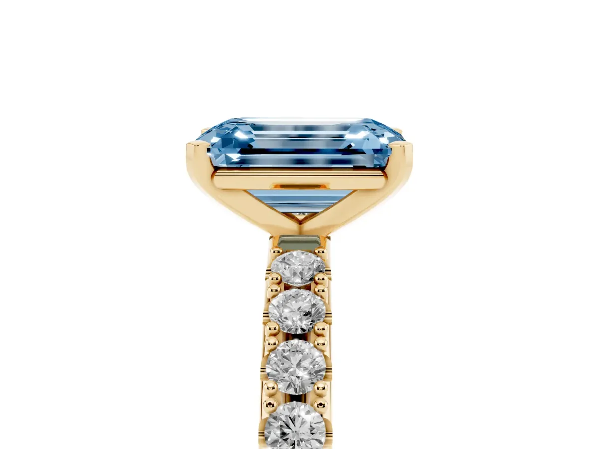 Fancy Blue Emerald Cut Diamond Solitaire Pavé Band with Four-Prong Setting Yellow gold
