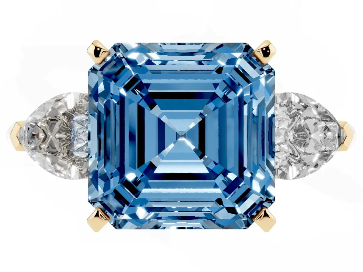 Fancy Blue Three-Stone Asscher Cut Diamond Ring with Pear Side Stones and Four-Prong Setting Yellow gold