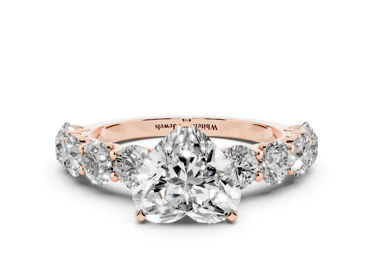 Heart Cut Diamond Prong Setting with Side Stones on a Pave Band Rose gold