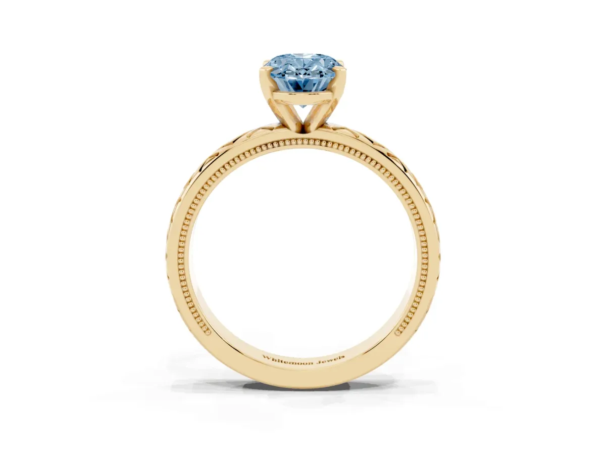 Fancy Blue Oval Cut Solitaire Diamond Ring with Milgrain and Black Enamel X Pattern Band Yellow gold