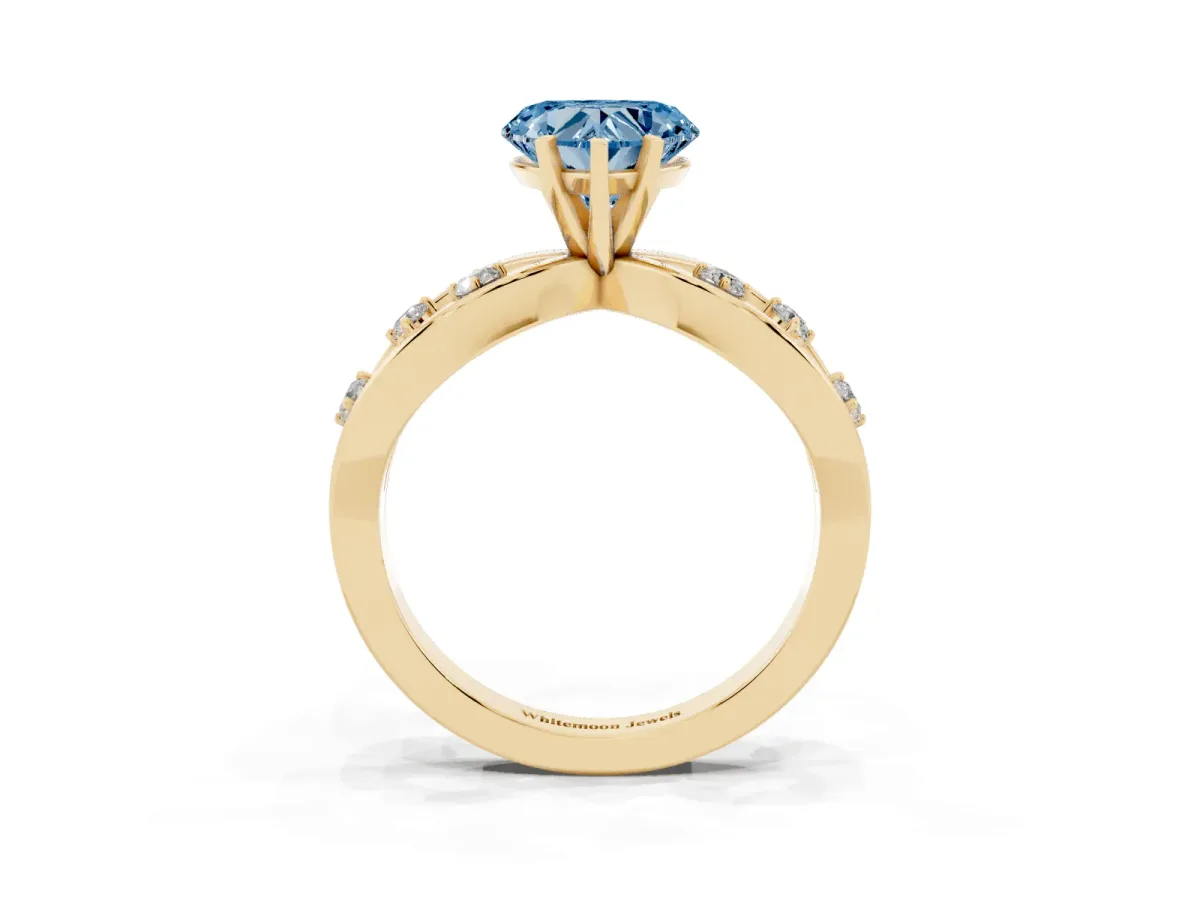 Fancy Blue Heart Cut Cut Solitaire Diamond with Side Stones on Criss-Cross Band and Four-Prong Setting Yellow gold