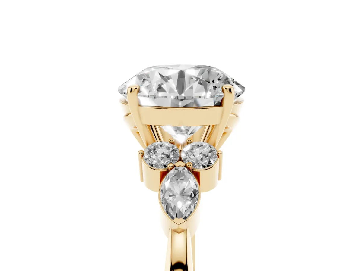 Round Cut Brilliant Diamond Solitaire Ring with Pear Side Stones and Four-Prong Setting Yellow gold
