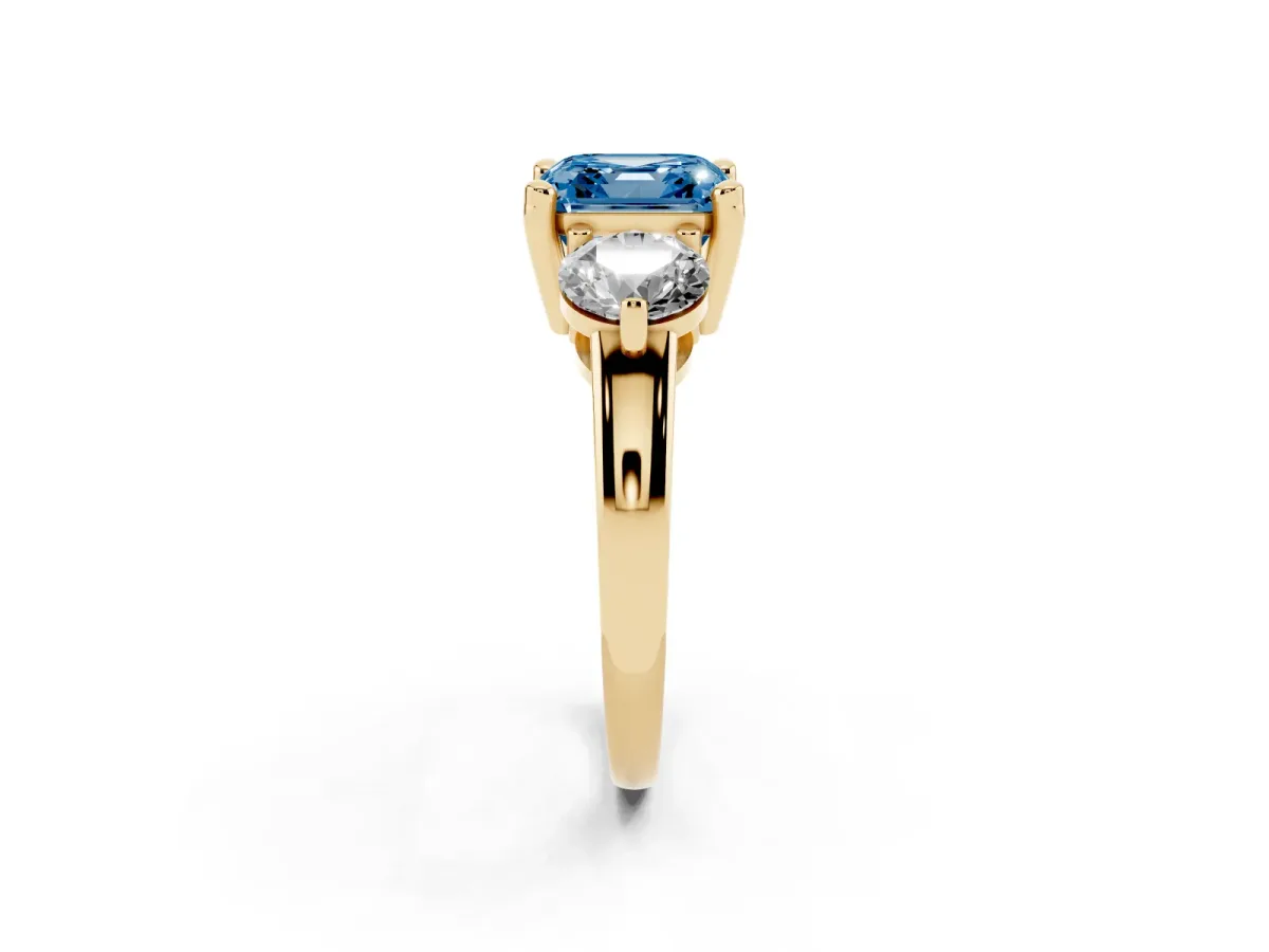 Fancy Blue Three-Stone Asscher Cut Brilliant Cut Solitaire Ring with Prong Setting on a Classic Band Yellow gold