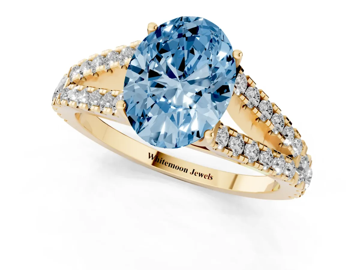 Fancy Blue Oval Cut Diamond Split Shank Engagement Ring with Round Pavé and Prong Setting Yellow gold