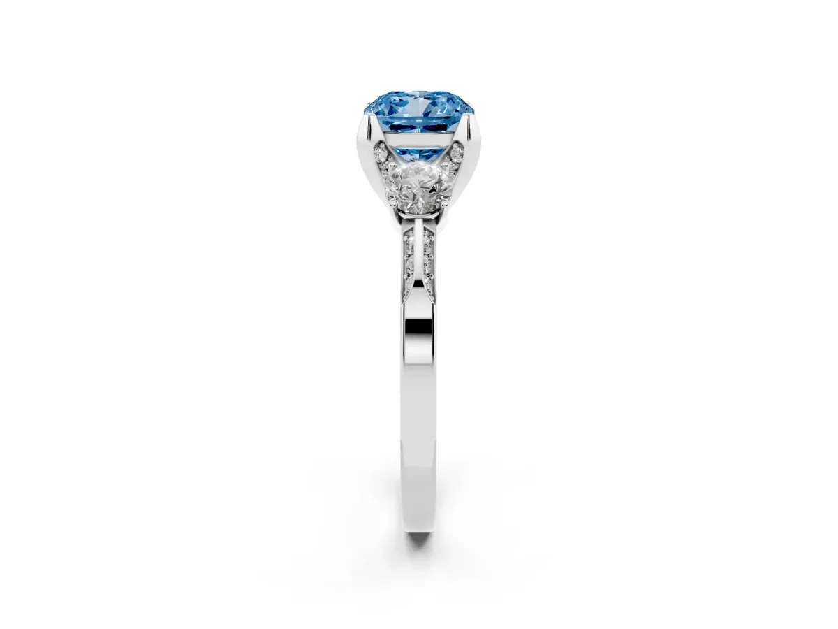 Fancy Blue Cushion Cut Brilliant Three-Stone Diamond Ring with Pavé Band and Four-Prong Setting White gold
