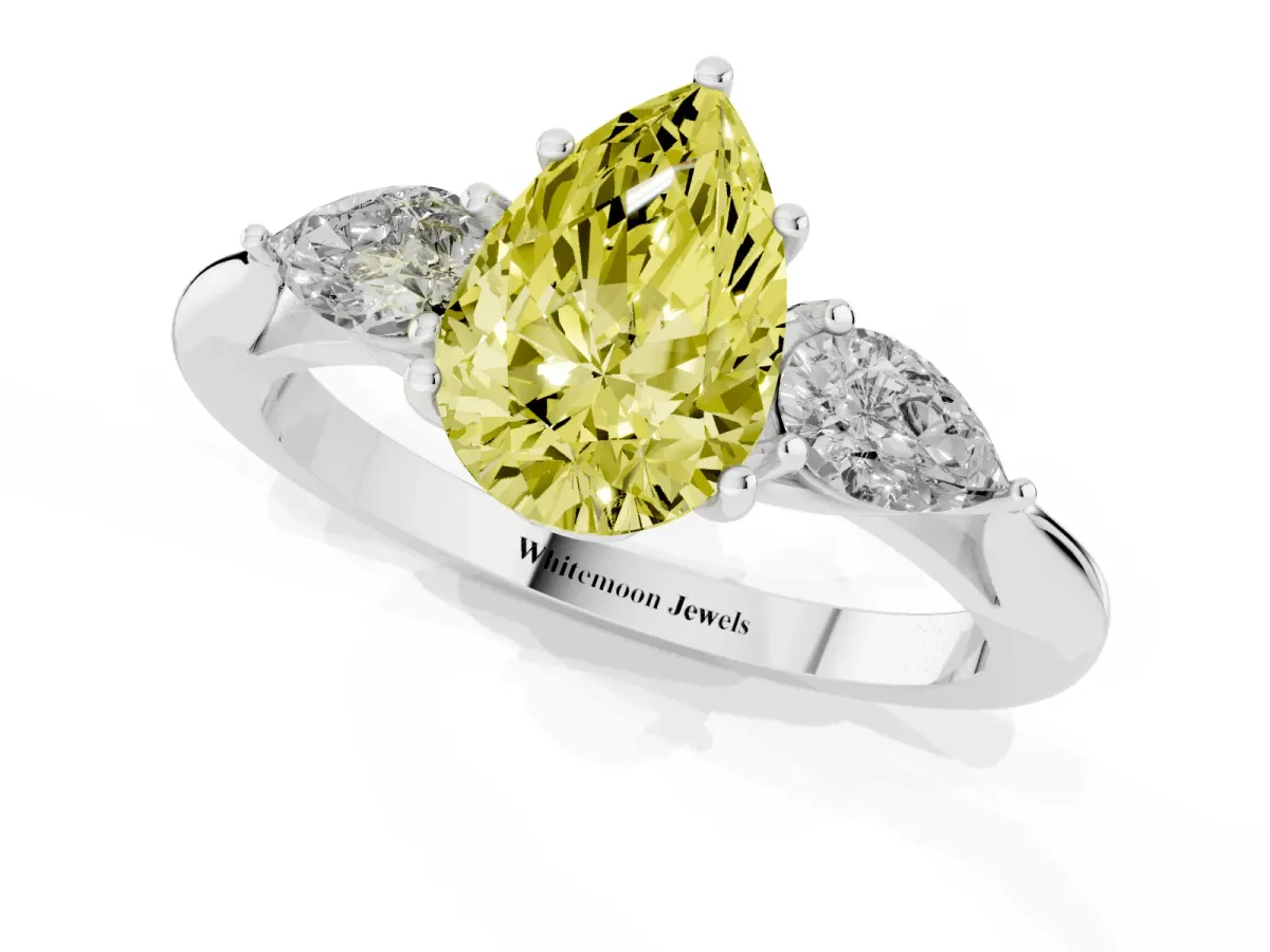Fancy Yellow Three-Stone Pear Cut Brilliant Diamond Solitaire Ring with Tapered Band and Four-Prong Setting Platinum