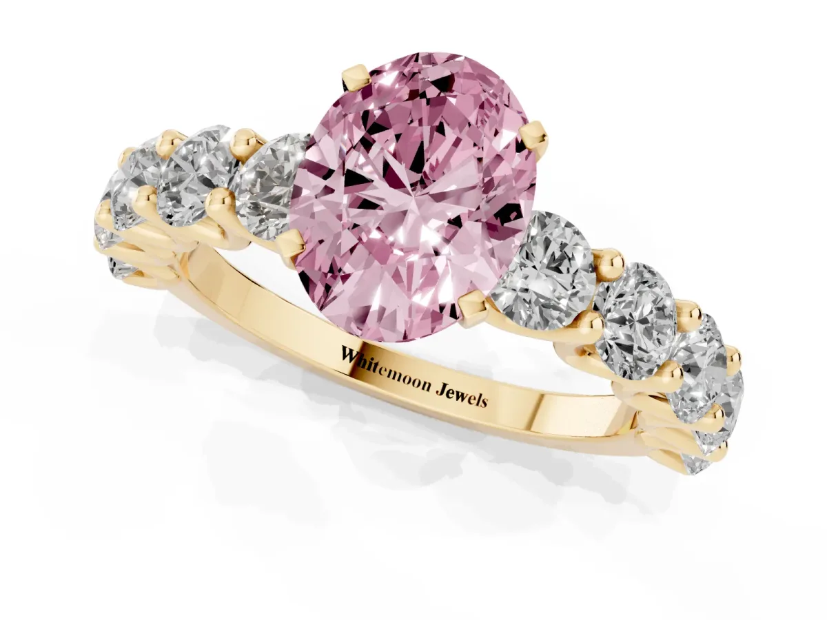 Fancy Pink Oval Cut Diamond Prong Setting with Side Stones on a Pave Band Yellow gold