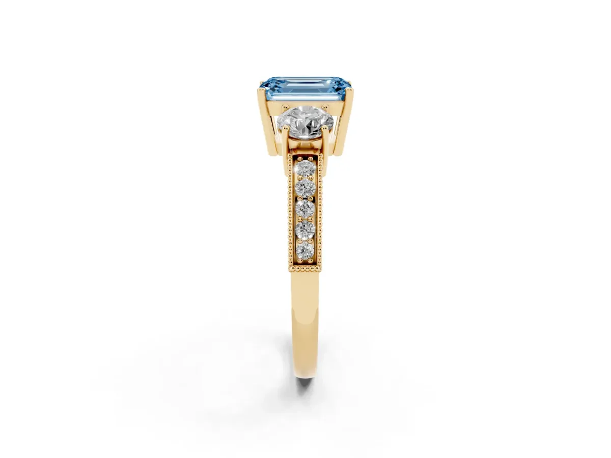 Fancy Blue Emerald Cut Three-Stone Diamond Ring with Pavé Band and Four-Prong Setting Yellow gold