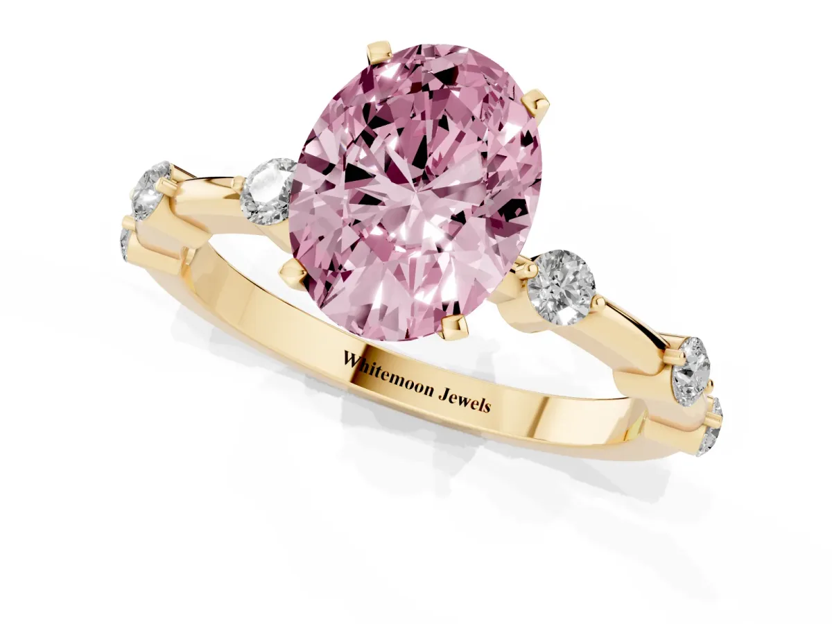 Fancy Pink Oval Cut Solitaire Diamond Ring with Bezel Set Side Stones and Prong Setting Yellow gold