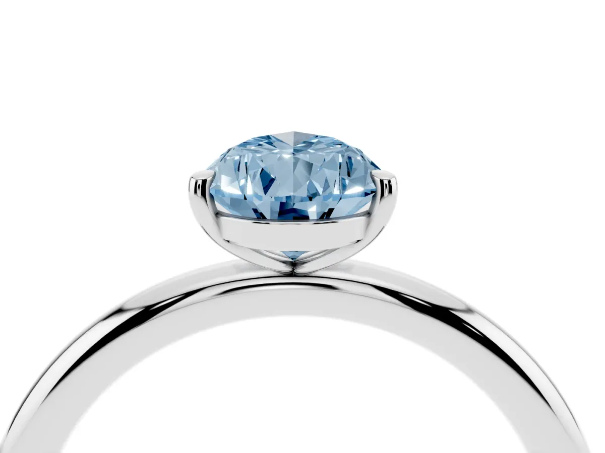 Fancy Blue Pear Cut Solitaire Diamond Ring with Four-Prong Setting on a Plain Band Silver