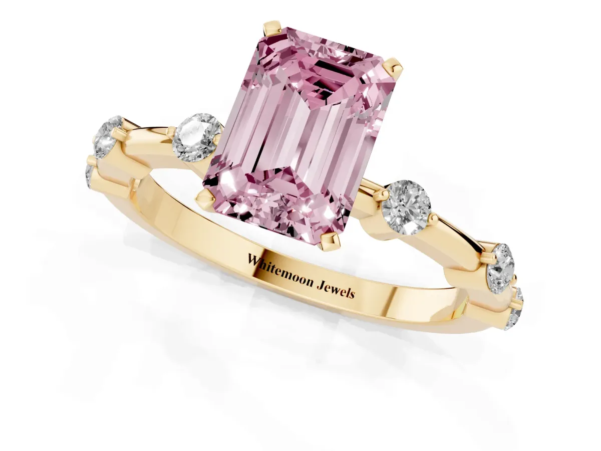 Fancy Pink Emerald Cut Solitaire Diamond Ring with Bezel Set Side Stones and Prong Setting Yellow gold