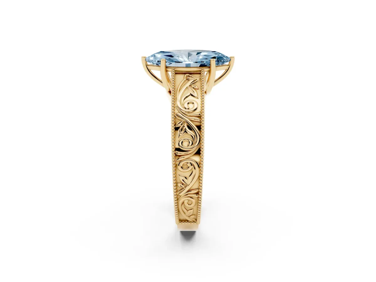 Fancy Blue Marquise Cut Diamond Solitaire Ring with Engraved Band and Four-Prong Setting Yellow gold