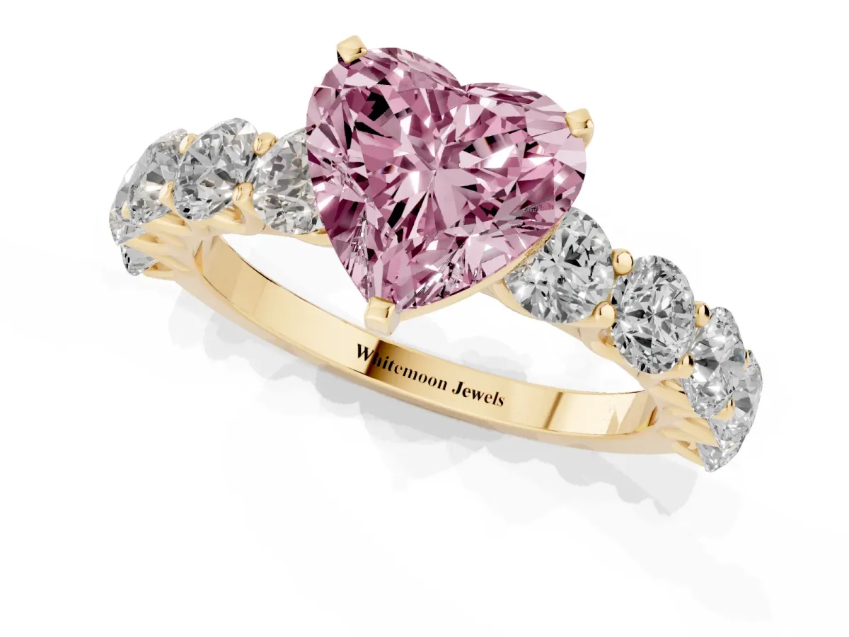 Fancy Pink Heart Cut Diamond Prong Setting with Side Stones on a Pave Band Yellow gold
