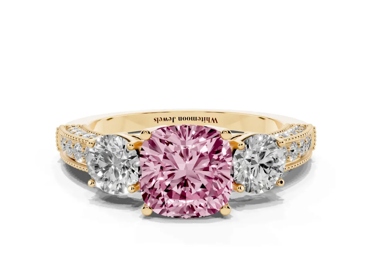 Fancy Pink Cushion Cut Three-Stone Diamond Ring with Pavé Band and Four-Prong Setting Yellow gold