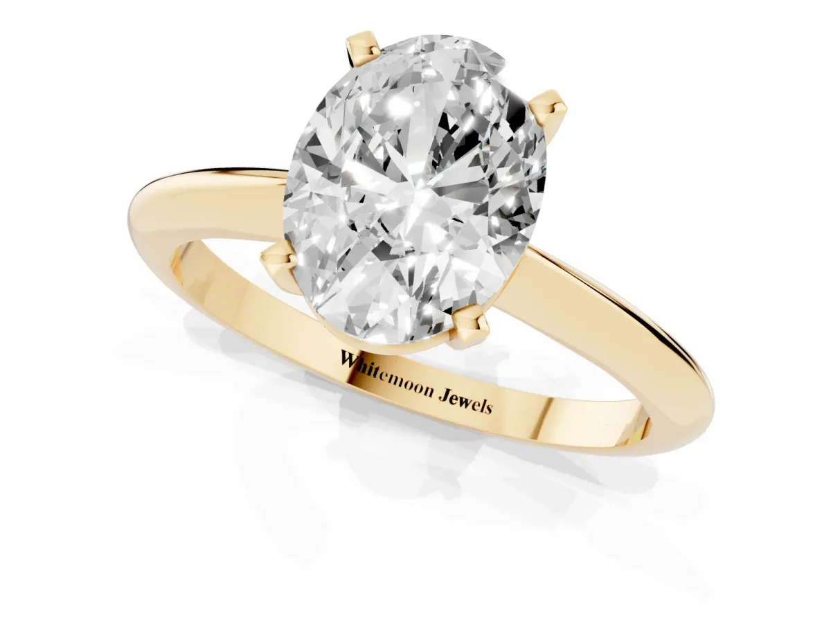 Oval Cut Cut Solitaire Ring with Four-Prong Setting on a Classic Band Yellow gold