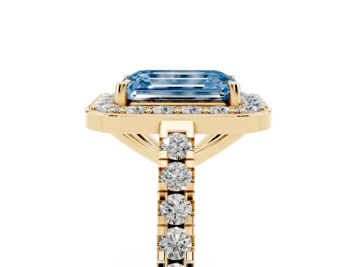 Fancy Blue Emerald Cut Diamond Halo Ring with Round Pavé Split Shank and Prong Setting Yellow gold