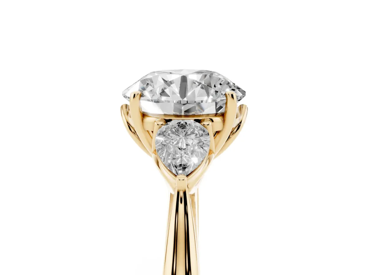 Three-Stone Round Cut Diamond Ring with Pear Side Stones in Four-Prong Setting Yellow gold