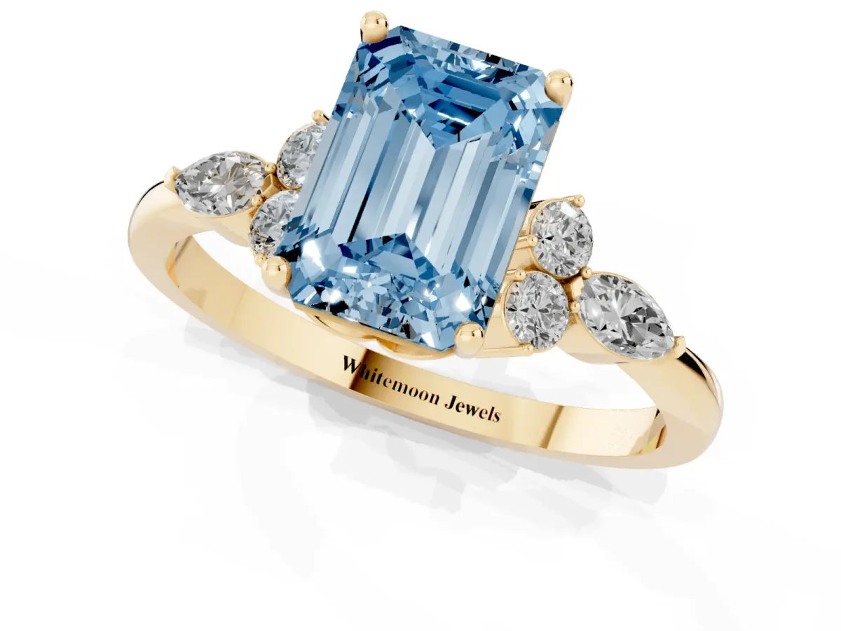 Fancy Blue Emerald Cut Brilliant Diamond Solitaire Ring with Pear Side Stones and Four-Prong Setting Yellow gold
