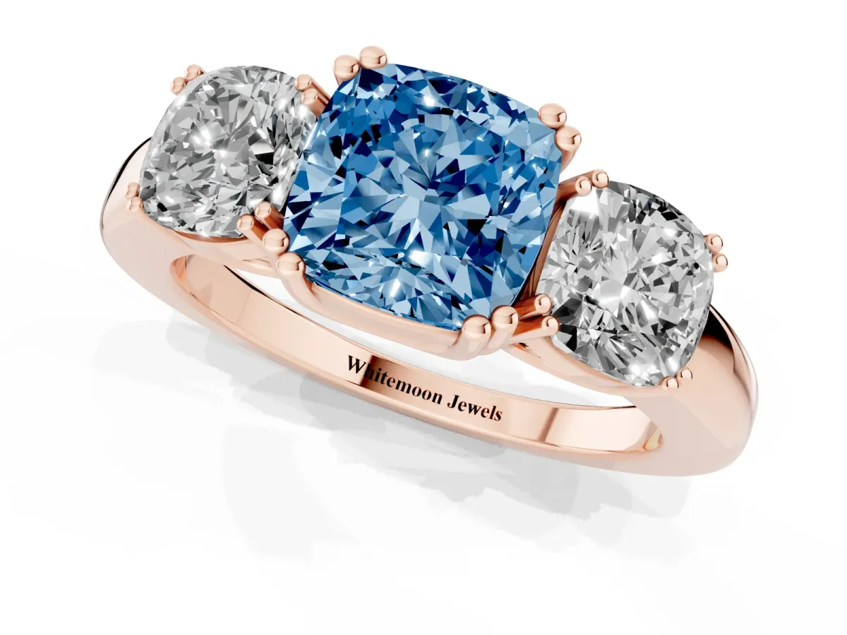 Fancy Blue Three-Stone Cushion Cut Cut Diamond Ring with Channel Set Band and Four-Prong Setting Rose gold