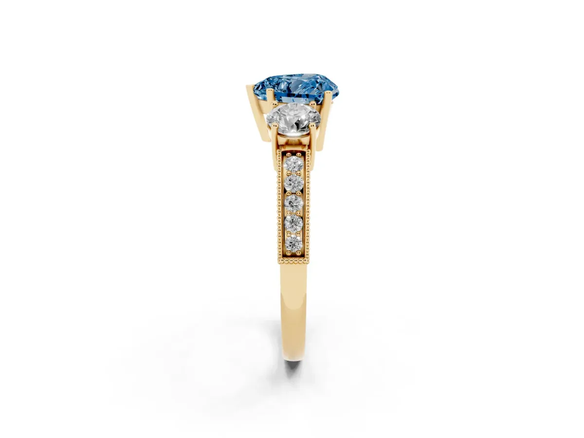 Fancy Blue Heart Cut Three-Stone Diamond Ring with Pavé Band and Four-Prong Setting Yellow gold