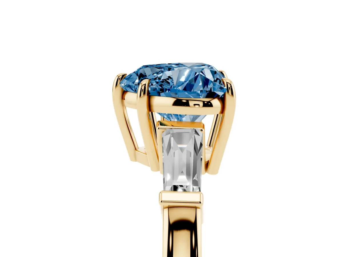 Fancy Blue Heart Cut Diamond Three-Stone Ring with Tapered Baguette Side Stones and Prong Setting Yellow gold