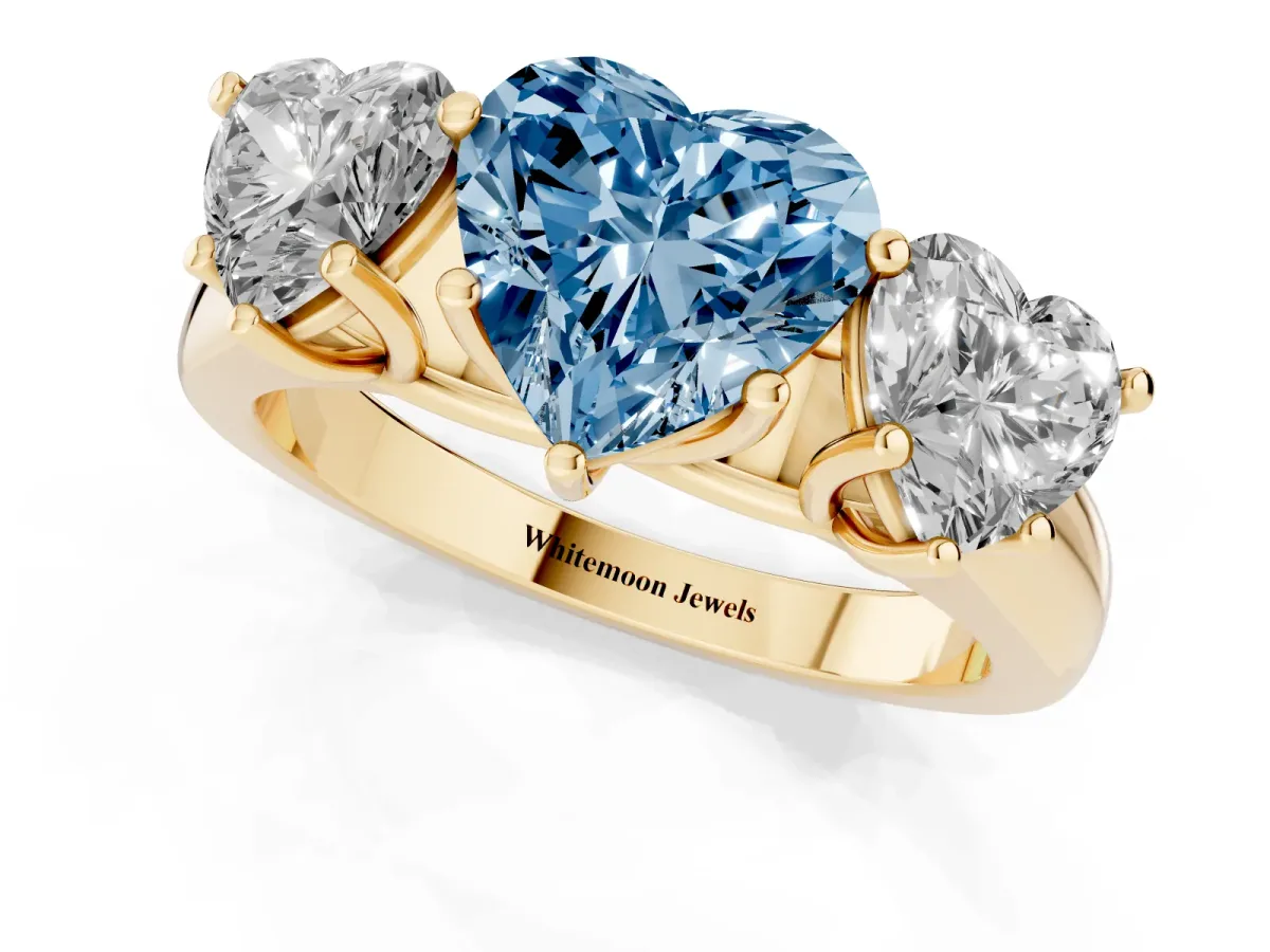 Fancy Blue Heart Cut Three-Stone Diamond Ring with Prong Setting on a Classic Band Yellow gold
