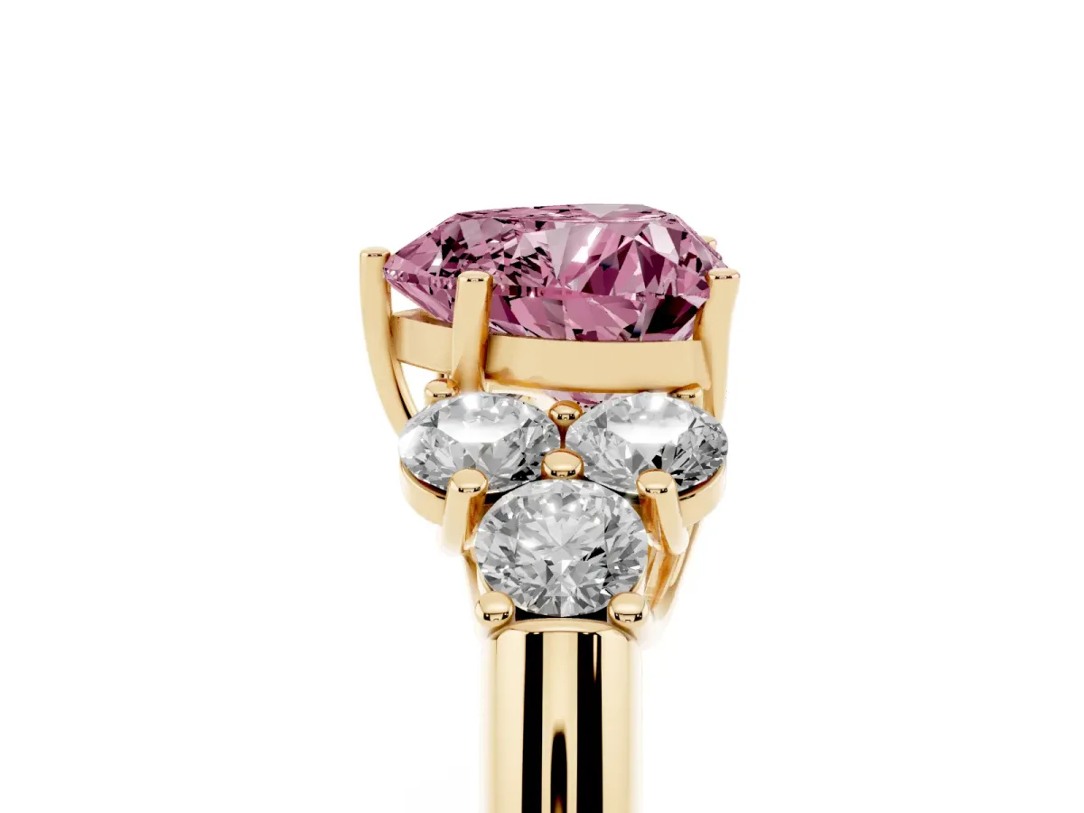 Fancy Pink Heart Cut Cut Diamond Cluster Ring with Round Accent Stones and Prong Setting on a Classic Band Yellow gold