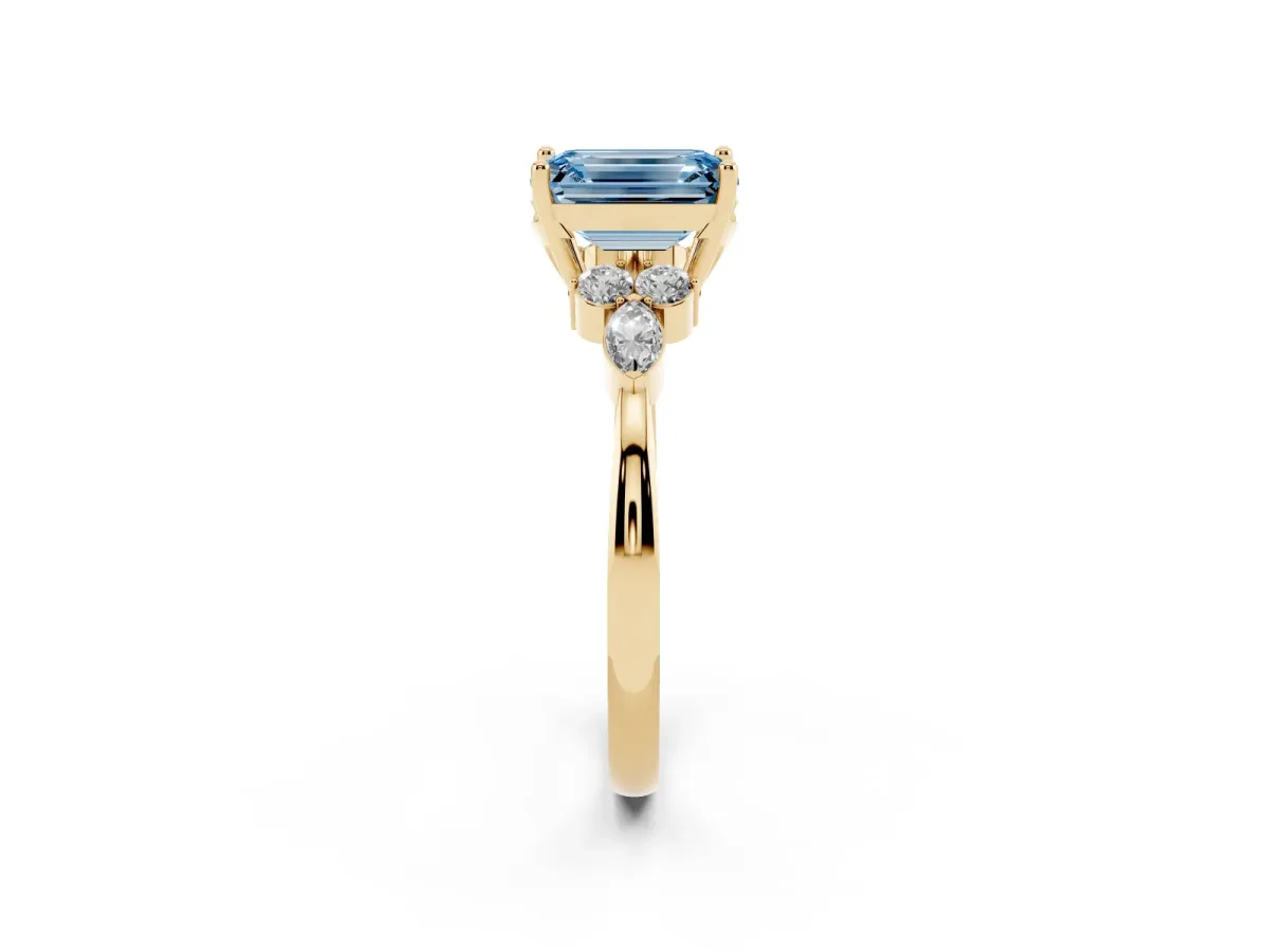 Fancy Blue Emerald Cut Brilliant Diamond Solitaire Ring with Pear Side Stones and Four-Prong Setting Yellow gold