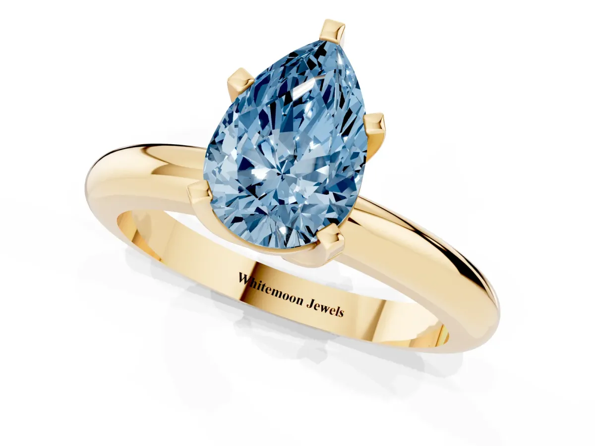 Fancy Blue Pear Cut Diamond Solitaire Engagement Ring with Round Band and Four-Prong Setting Yellow gold