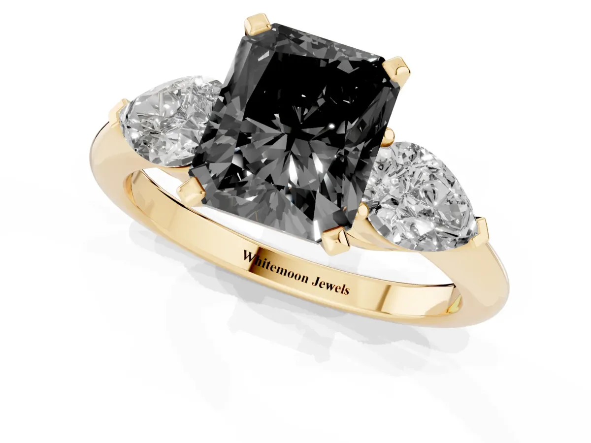 Fancy Black Three-Stone Radiant Cut Diamond Ring with Pear Side Stones and Four-Prong Setting Yellow gold