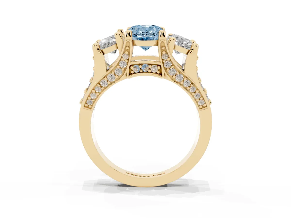 Fancy Blue Oval Cut Diamond Three-Stone Ring with Channel Set Band and Four-Prong Setting Yellow gold