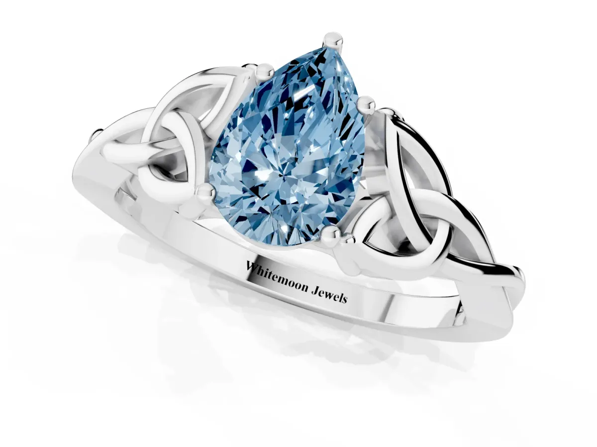 Fancy Blue Pear Cut Diamond Solitaire Engagement Ring with Celtic Knot Band and Four-Prong Setting Silver