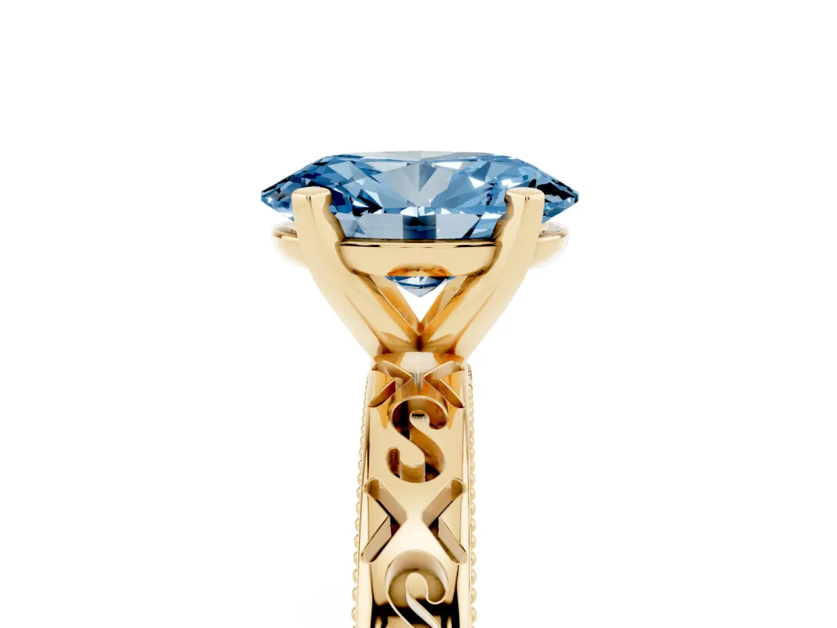 Fancy Blue Oval Cut Solitaire Engagement Ring with Scrollwork Band and Four-Prong Setting Yellow gold