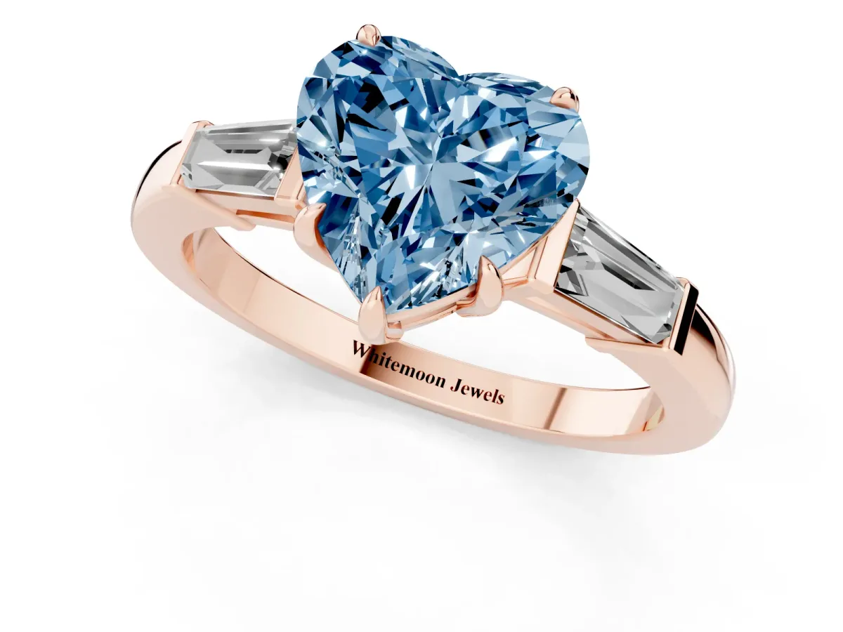 Fancy Blue Heart Cut Diamond Three-Stone Ring with Tapered Baguette Side Stones and Prong Setting Rose gold