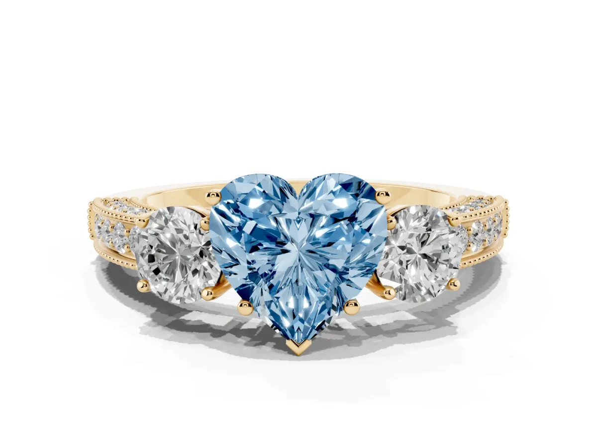 Fancy Blue Heart Cut Three-Stone Diamond Ring with Pavé Band and Four-Prong Setting Yellow gold