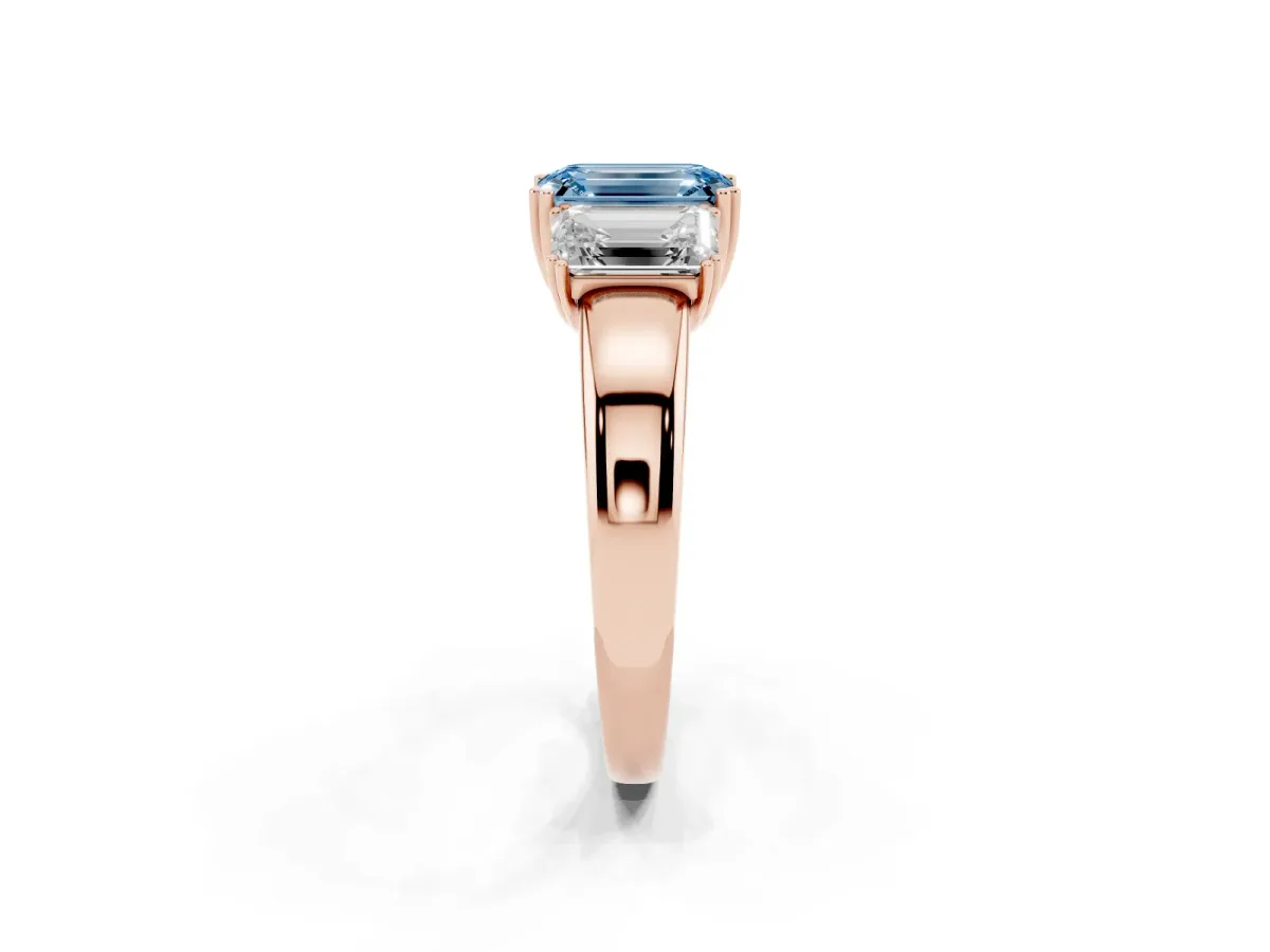 Fancy Blue Three-Stone Emerald Cut Cut Diamond Ring with Channel Set Band and Four-Prong Setting Rose gold