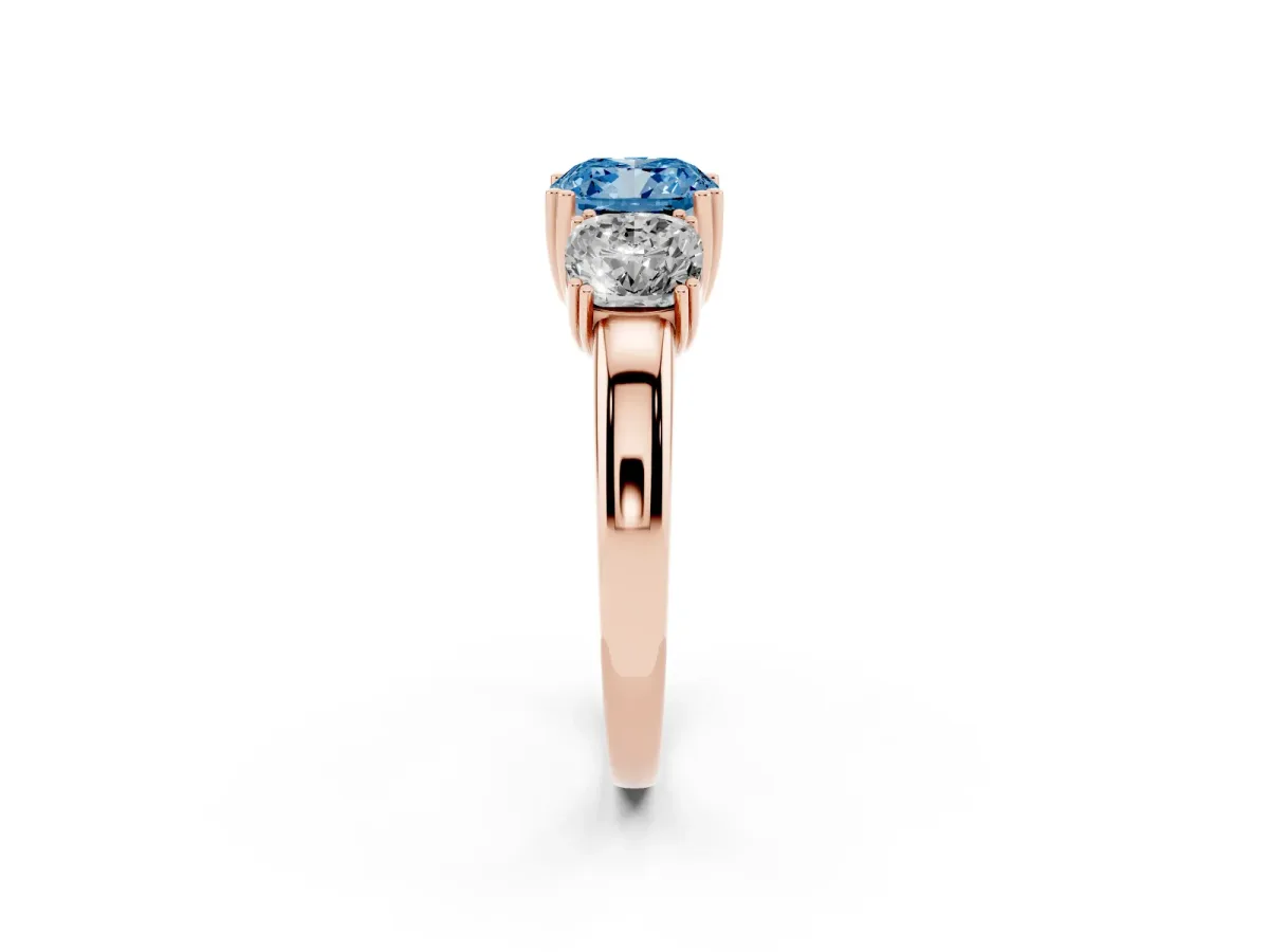 Fancy Blue Three-Stone Cushion Cut Cut Diamond Ring with Channel Set Band and Four-Prong Setting Rose gold