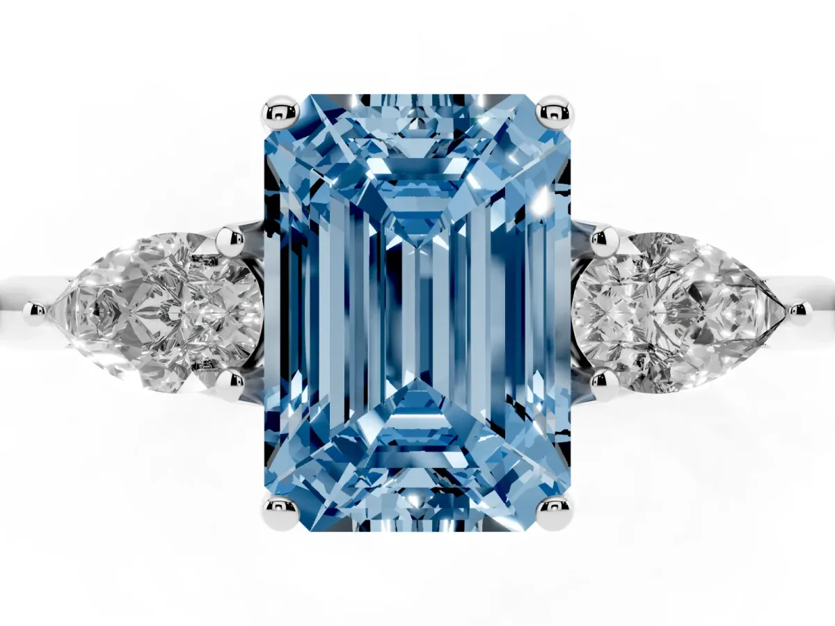 Fancy Blue Three-Stone Emerald Cut Diamond Ring with Pear Side Stones in Four-Prong Setting Silver