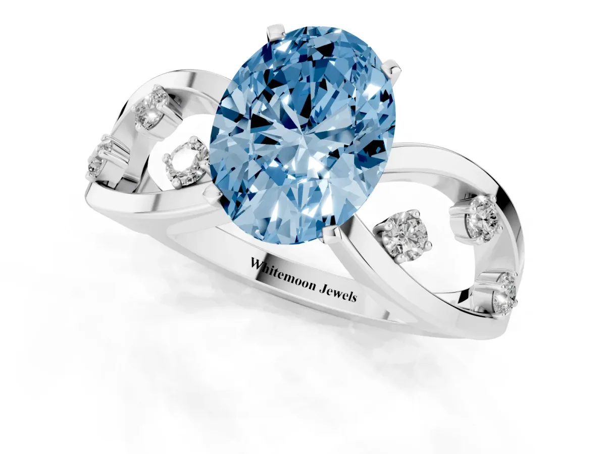Fancy Blue Oval Cut Cut Solitaire Diamond with Side Stones on Criss-Cross Band and Four-Prong Setting Silver