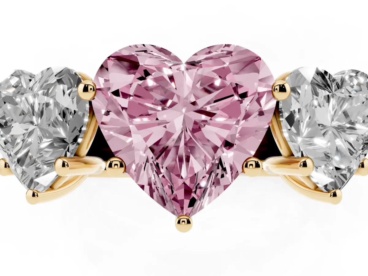 Fancy Pink Heart Cut Three-Stone Diamond Ring with Prong Setting on a Classic Band Yellow gold
