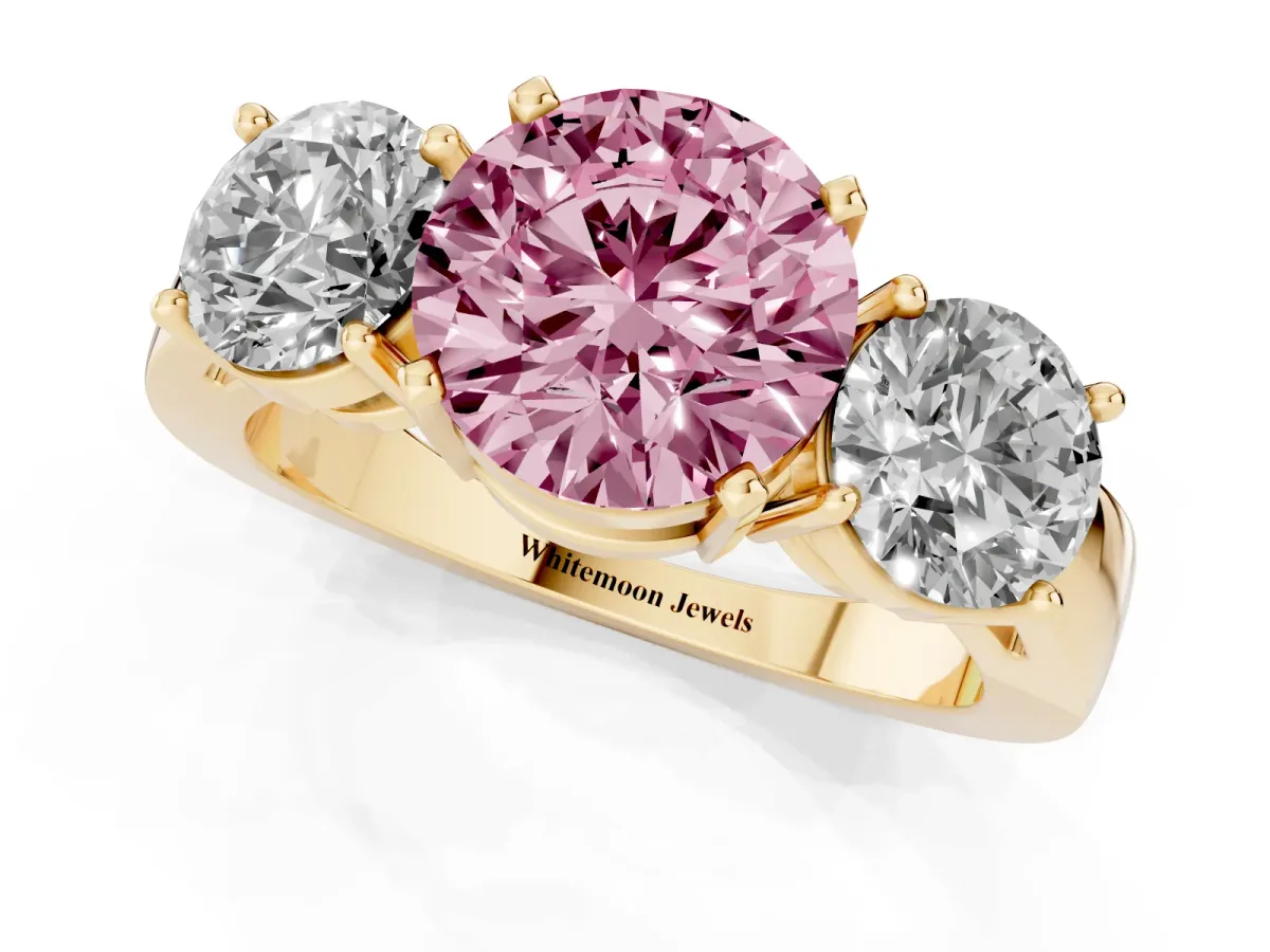 Fancy Pink Three-Stone Round Cut Diamond Ring with Round Side Stones, Classic Band, and Four-Prong Setting Yellow gold