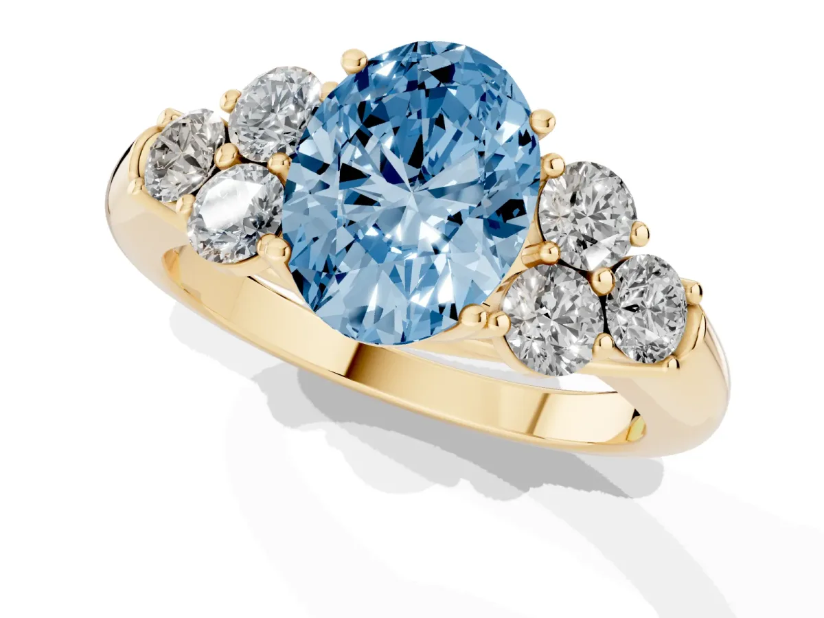 Fancy Blue Oval Cut Cut Diamond Cluster Ring with Round Accent Stones and Prong Setting on a Classic Band Yellow gold