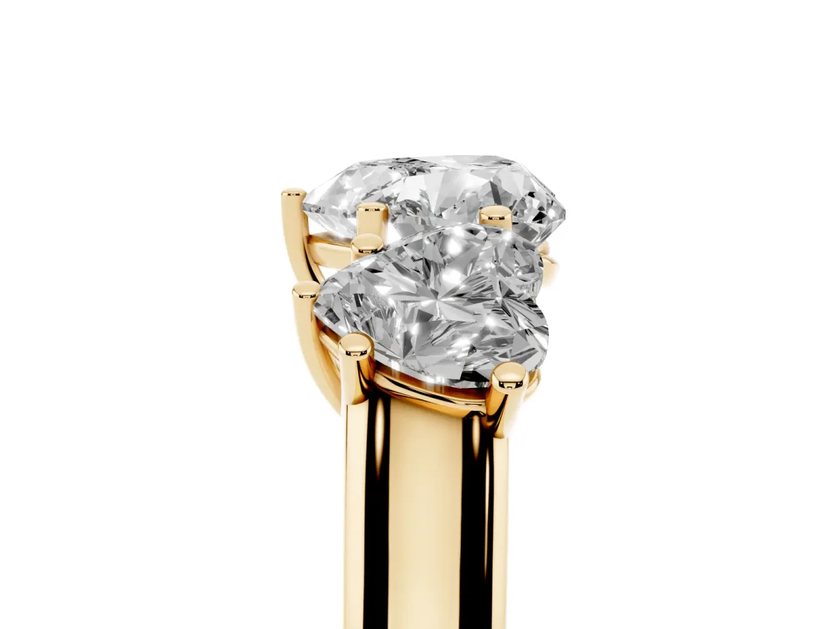 Heart Cut Three-Stone Diamond Ring with Prong Setting on a Classic Band Yellow gold