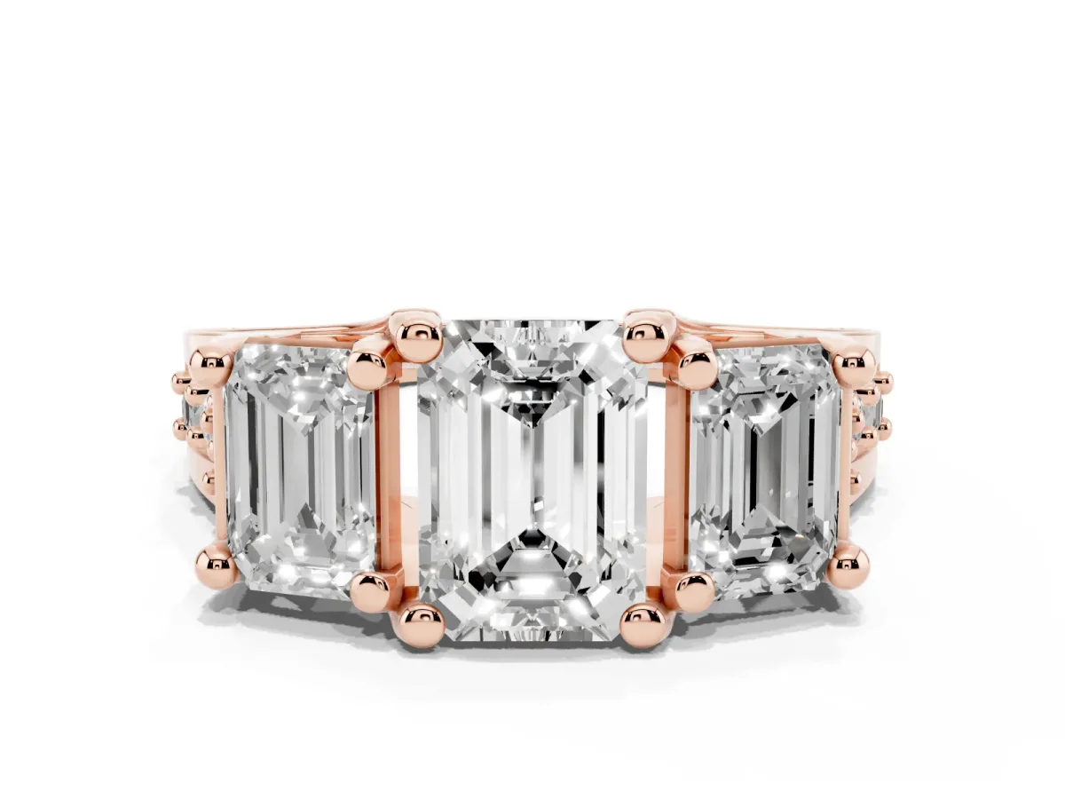 Emerald Cut Diamond Three-Stone Ring with Channel Set Band and Four-Prong Setting Rose gold