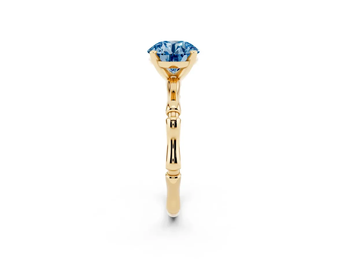 Fancy Blue Round Cut Solitaire Diamond Ring with Bamboo Band and Four-Prong Setting Yellow gold
