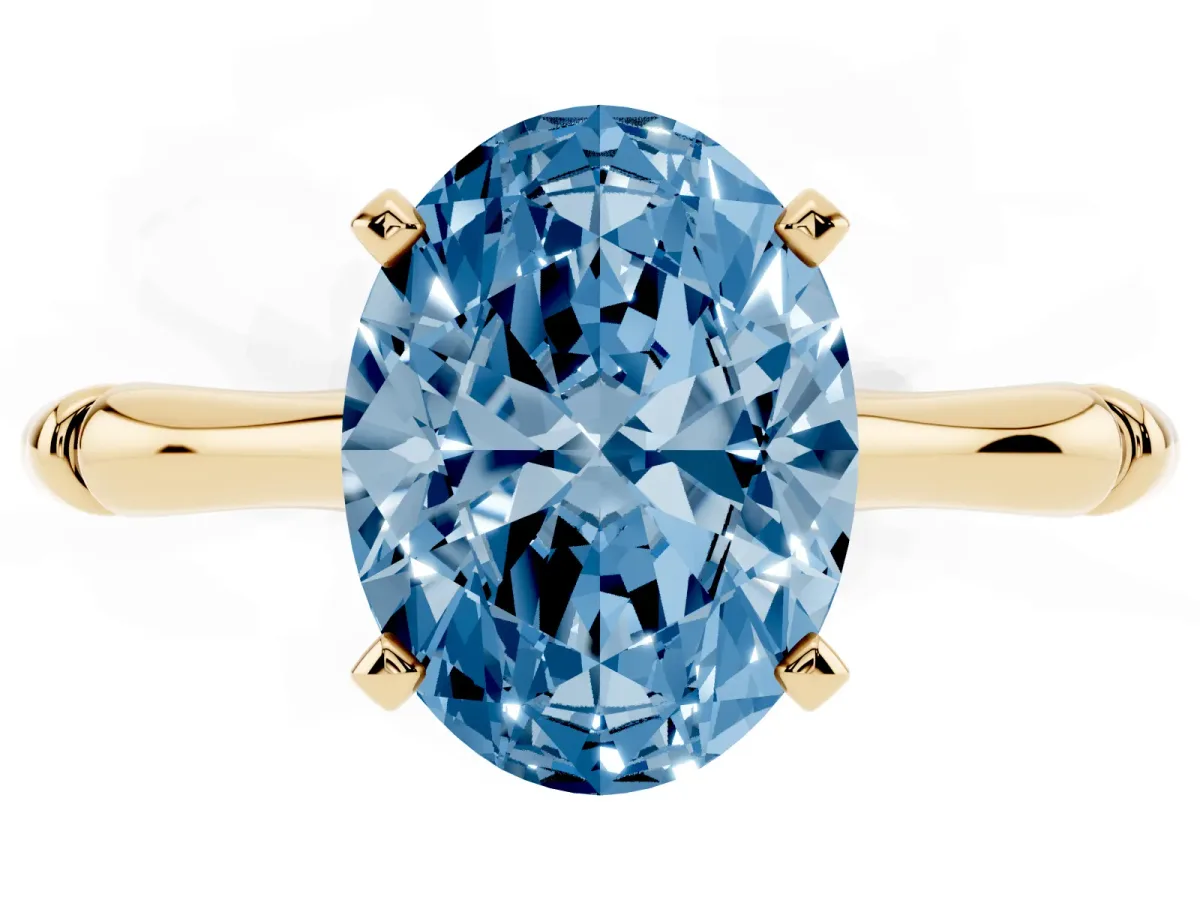 Fancy Blue Oval Cut Solitaire Diamond Ring with Bamboo Band and Four-Prong Setting Yellow gold